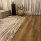 Eiche Eiche Apatura Klick-Vinylboden in Wohnzimmer mit beiger Couch, Teppich und Dekoration